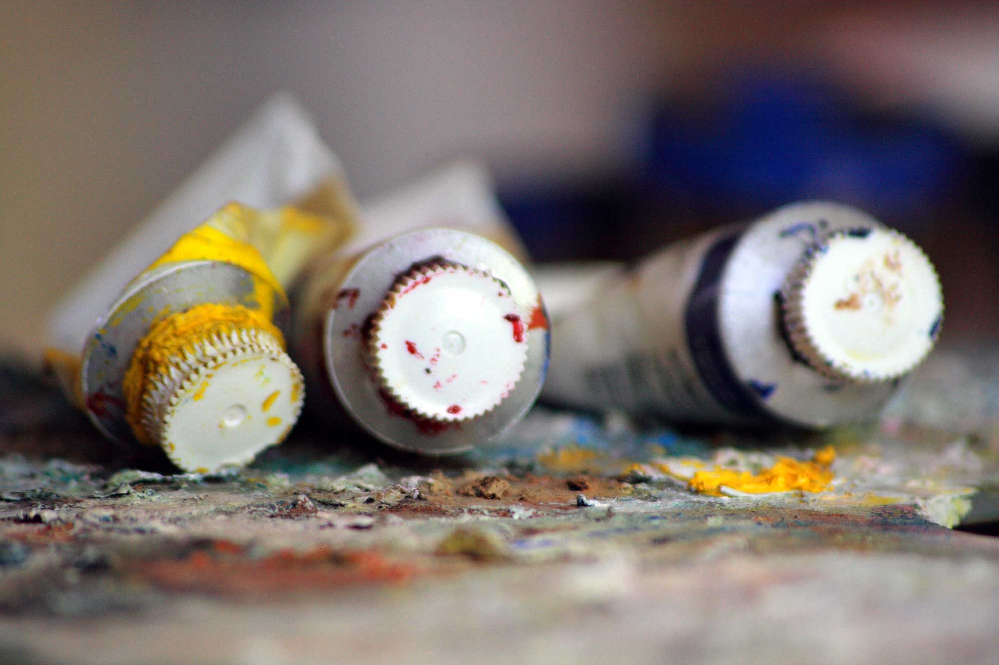 Three tubes of oil paint with the artist's palette.