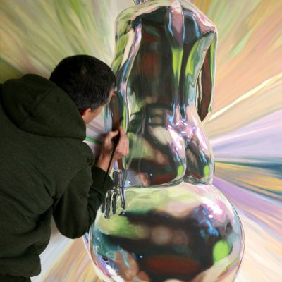 Artist Peter Strobos painting finer details of the female form.